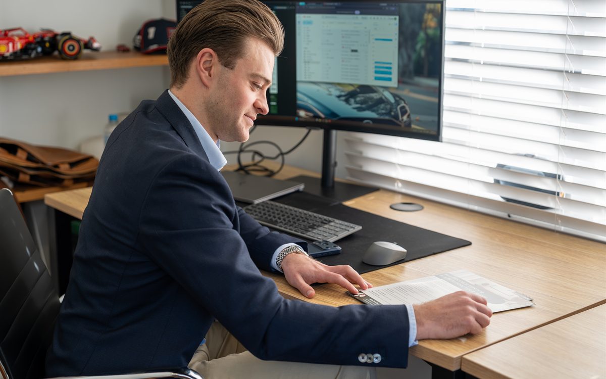 Alex Toohey going over a home loan application at his desk