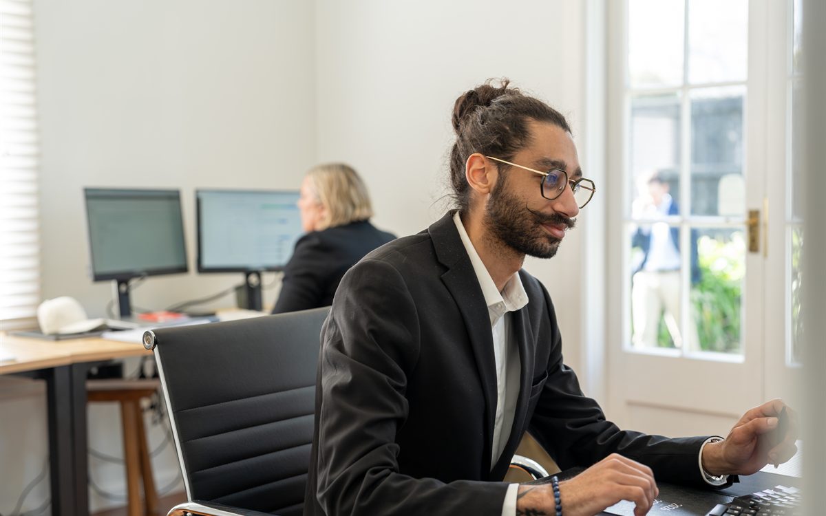 Sam working through lending numbers in the Journey Mortgages office